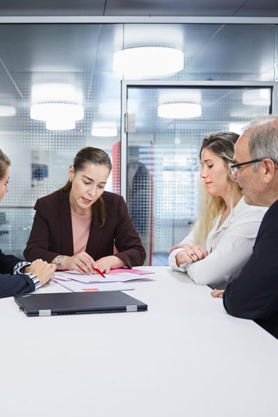Besprechung von 4 Personen an einem hohen Tisch