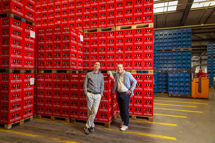 Zwei Männer vor einem Lager der Rugenbräu