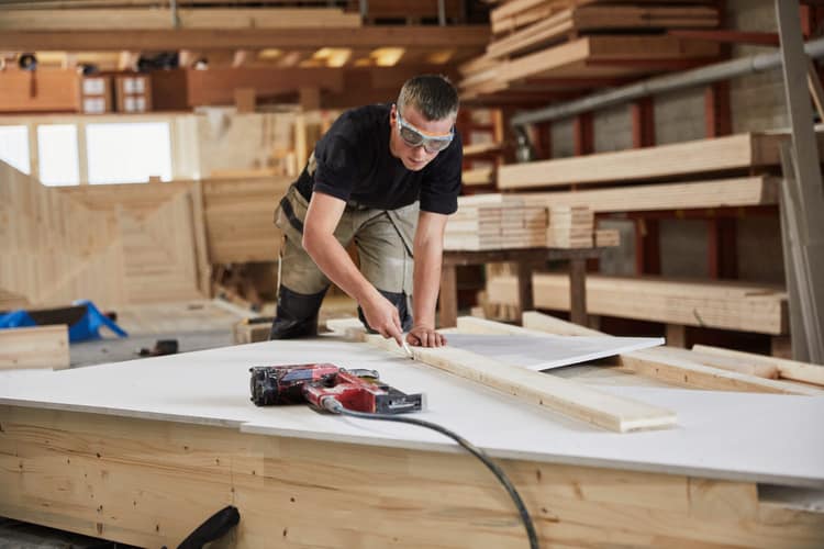 Handwerker bearbeitet Holz in einer Schreinerei, KMU 