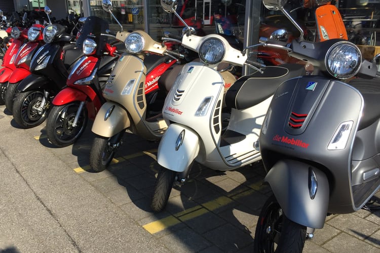 Verschiedene Roller stehen vor der Mobiliar Agentur.