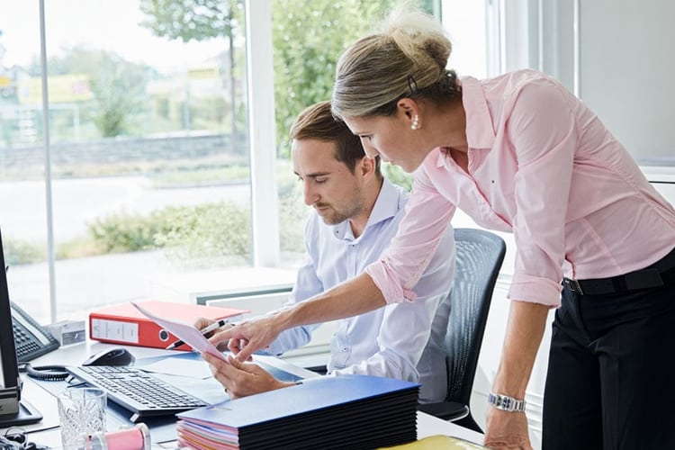 Due persone guardano uno schermo.