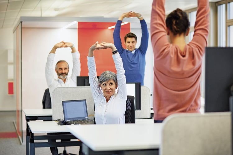 Le persone fanno esercizi di stretching in ufficio
