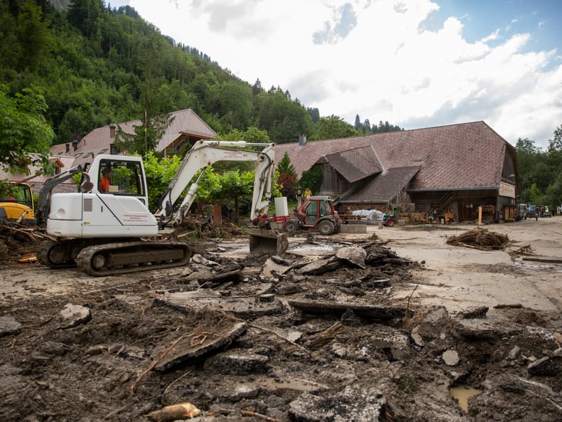 Bagger arbeitet sich durch das verwüstete Hotelareal Kemmeriboden-Bad nach dem Unwetter im Juli 2024