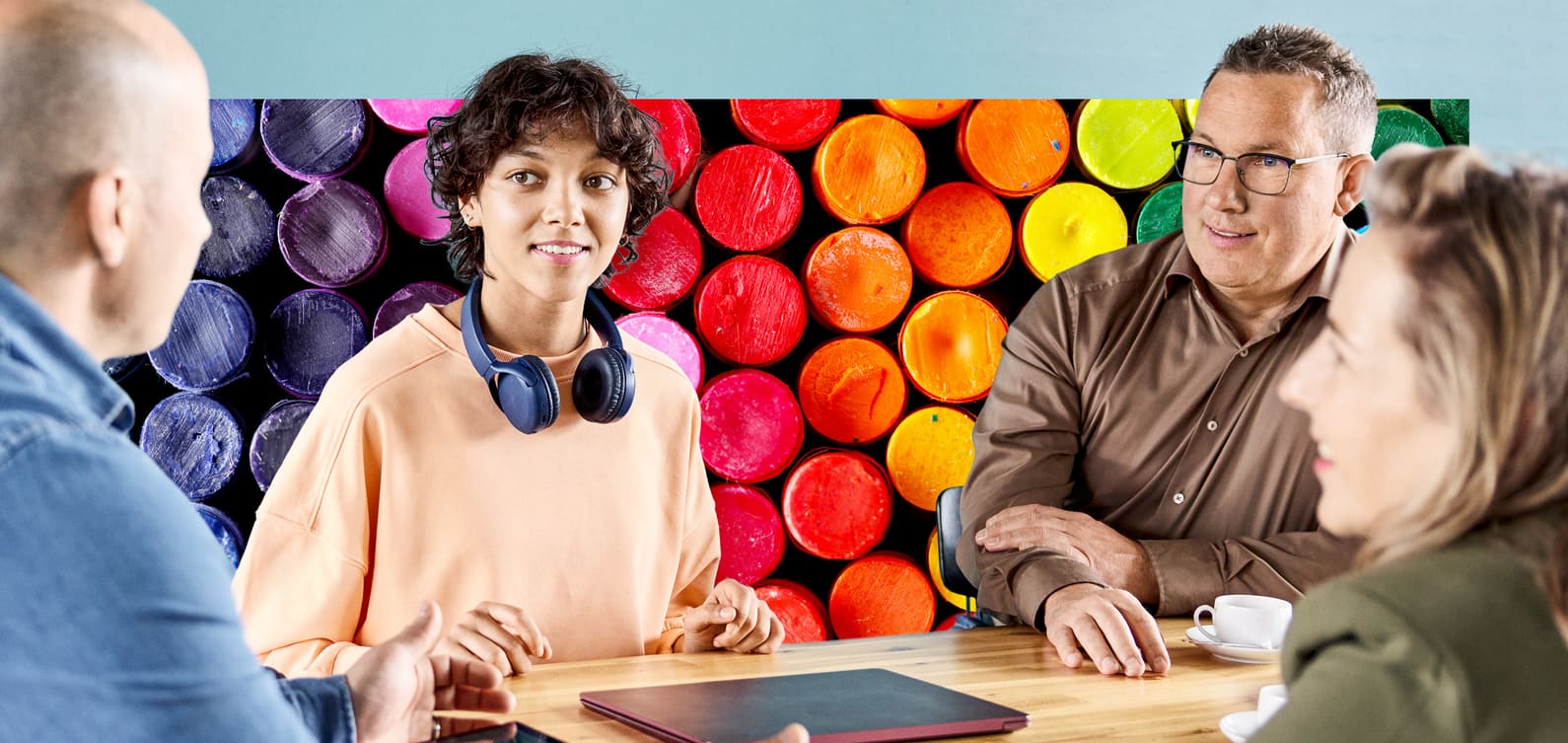 Mitarbeiterin mit Headset diskutiert mit ihren Arbeitskollegen